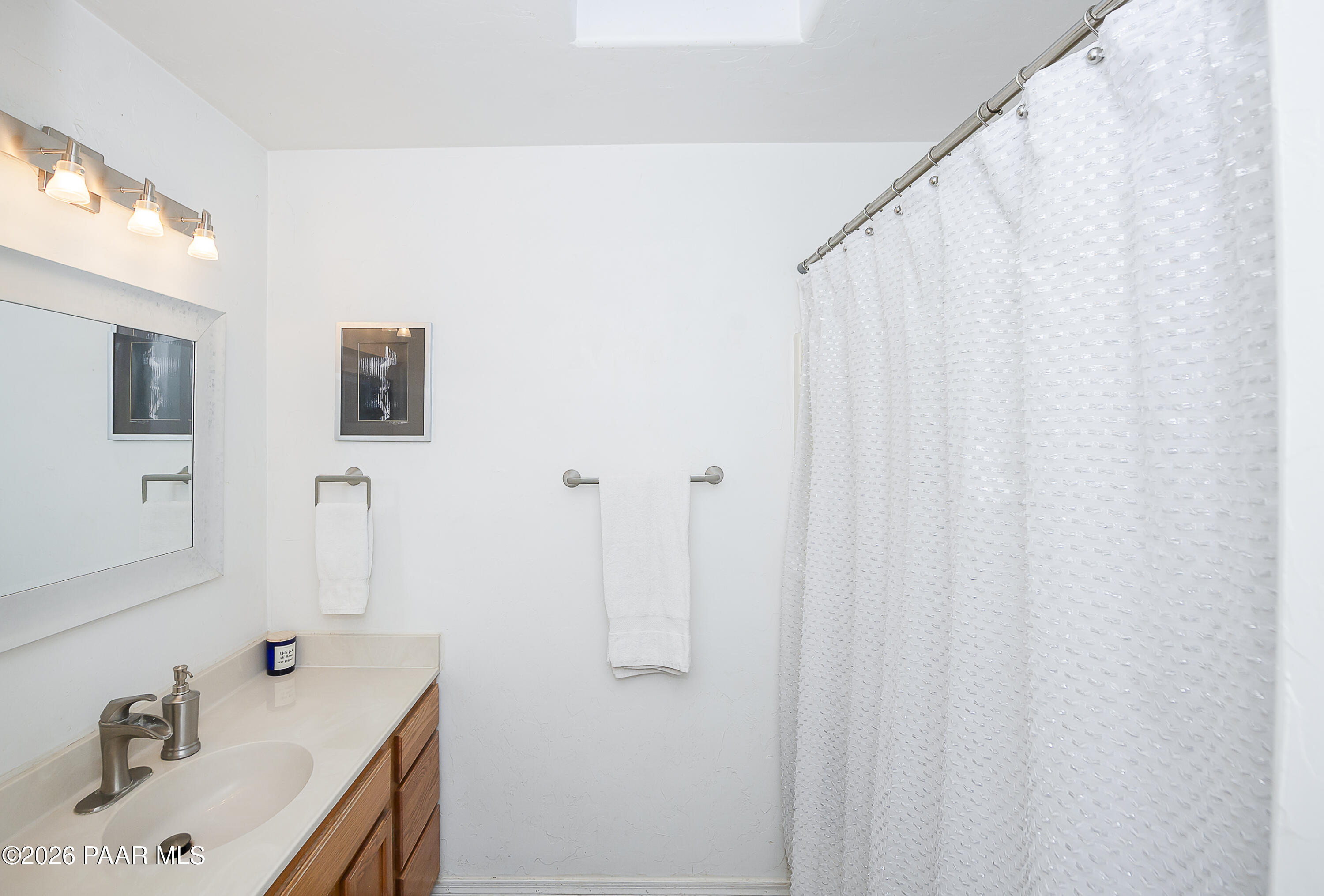 6565 Musgrove Road Skull Valley, AZ 86338 - Photo 23 of 65 a bathroom with a sink and a mirror