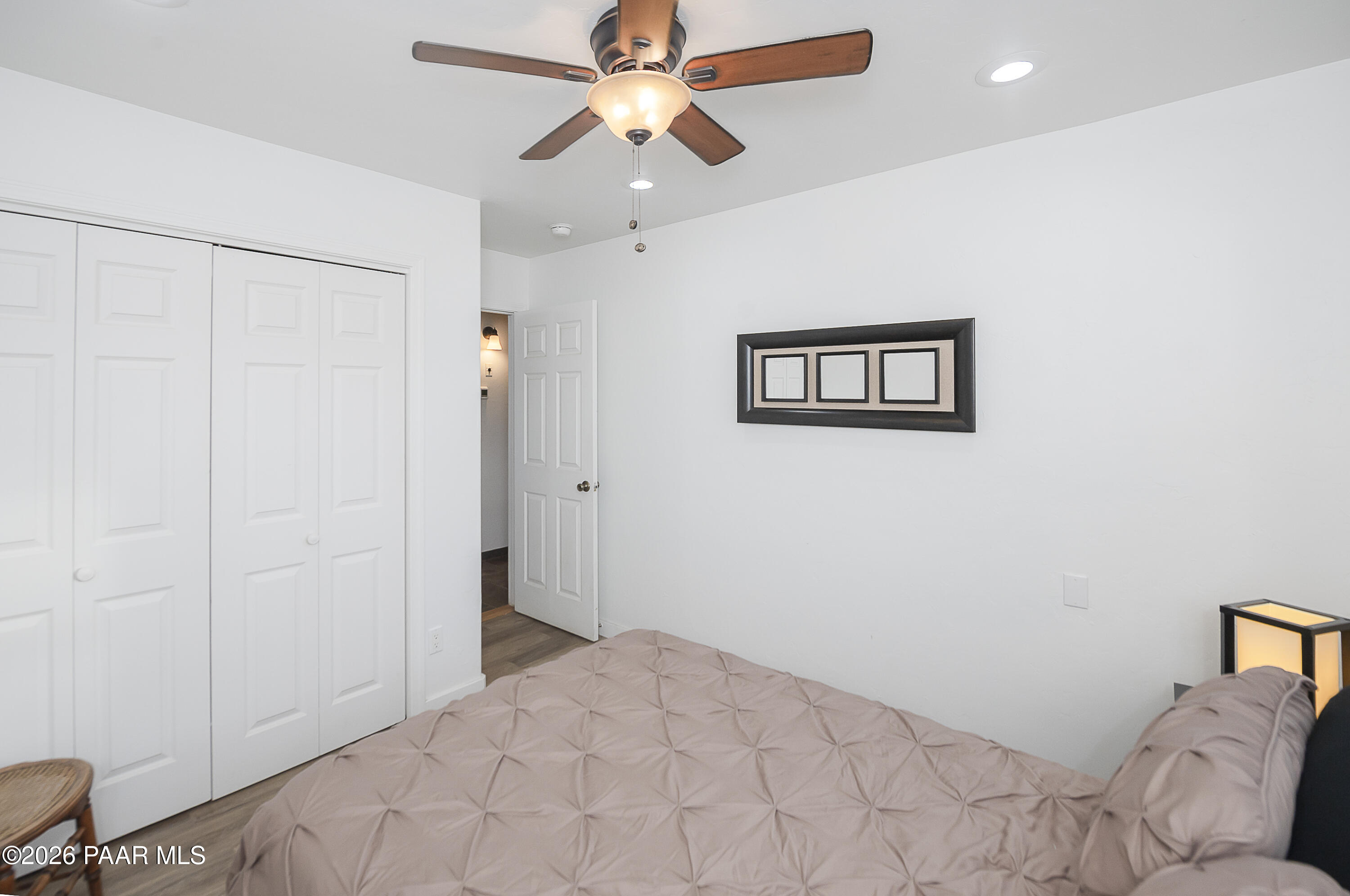 6565 Musgrove Road Skull Valley, AZ 86338 - Photo 27 of 65 a bedroom with a bed and a chandelier