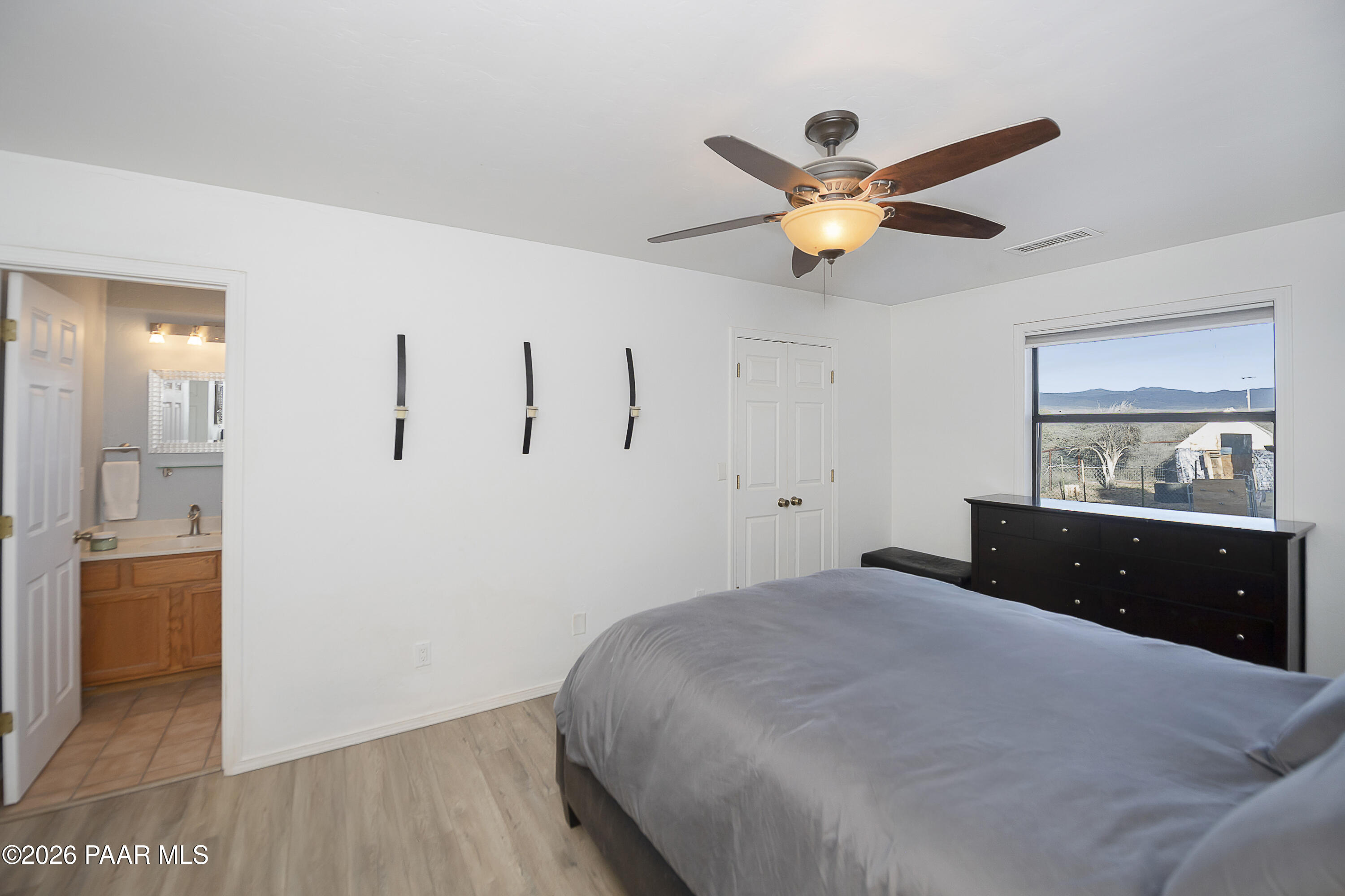 6565 Musgrove Road Skull Valley, AZ 86338 - Photo 30 of 65 a bedroom with a bed and a chandelier