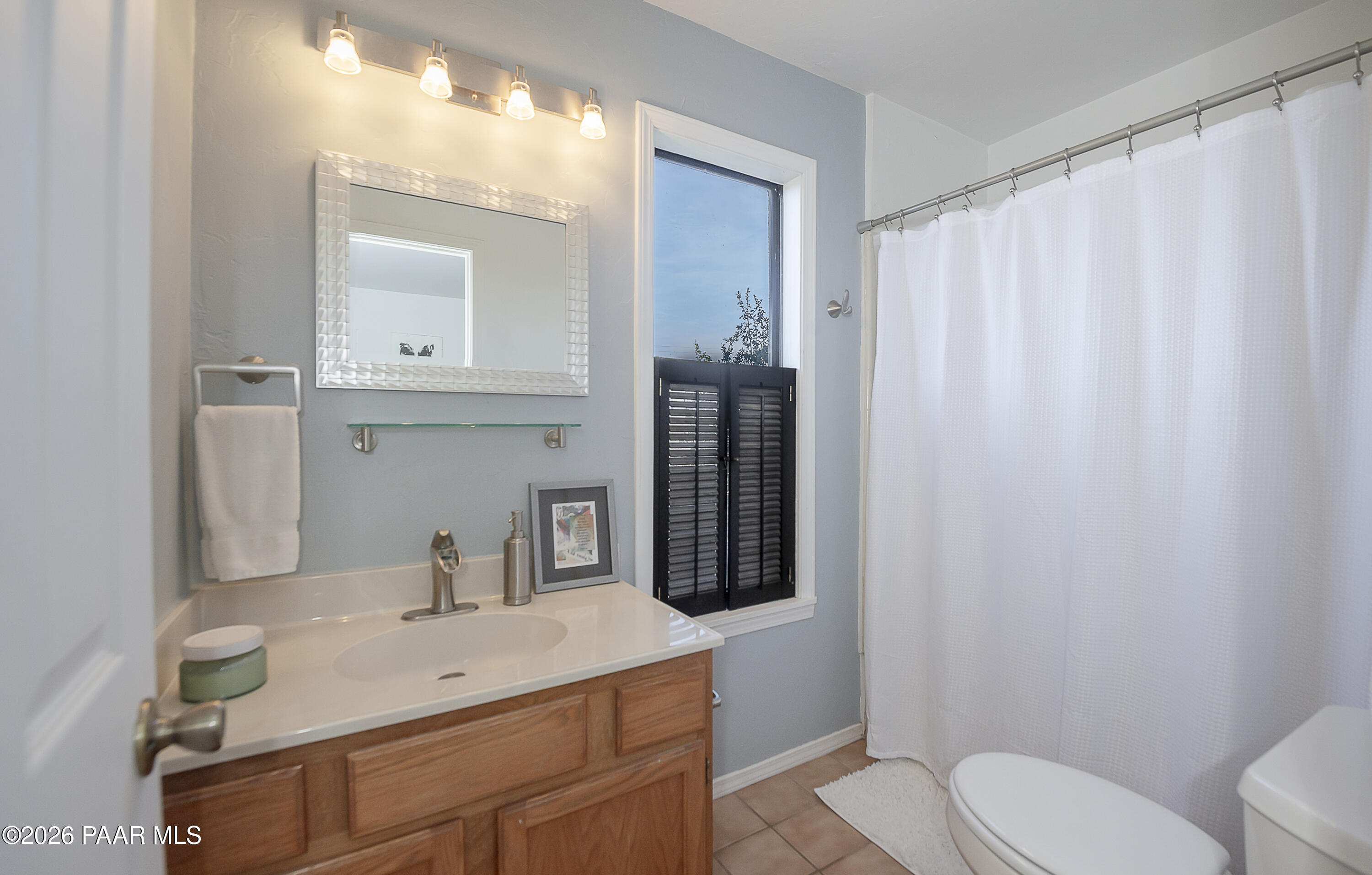 6565 Musgrove Road Skull Valley, AZ 86338 - Photo 33 of 65 a bathroom with a sink toilet and shower
