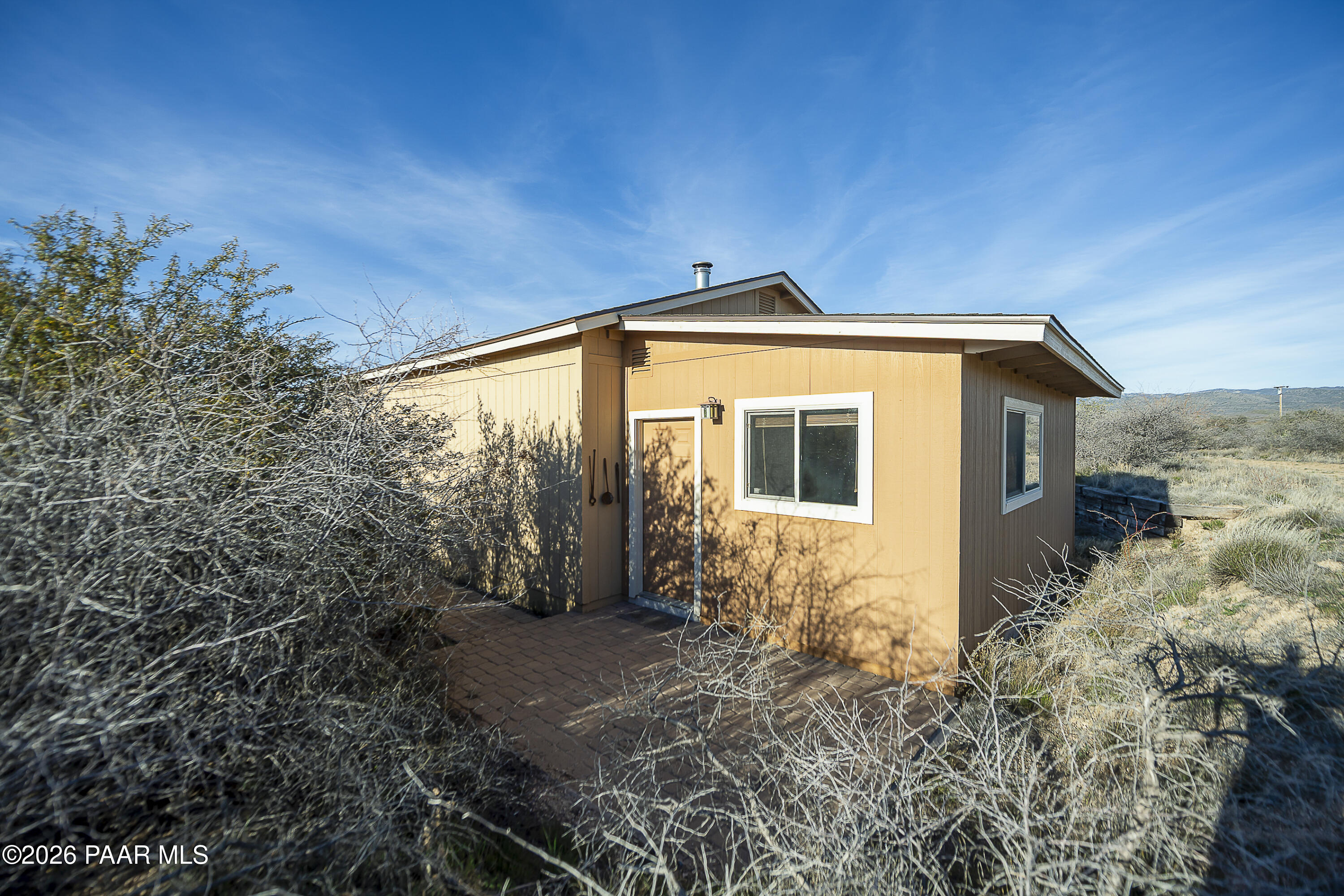 6565 Musgrove Road Skull Valley, AZ 86338 - Photo 50 of 65 a front view of a house with yard and trees