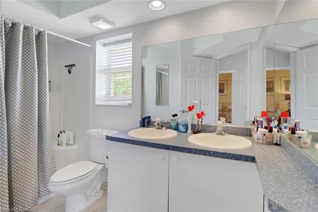 a bathroom with a toilet a sink and a mirror