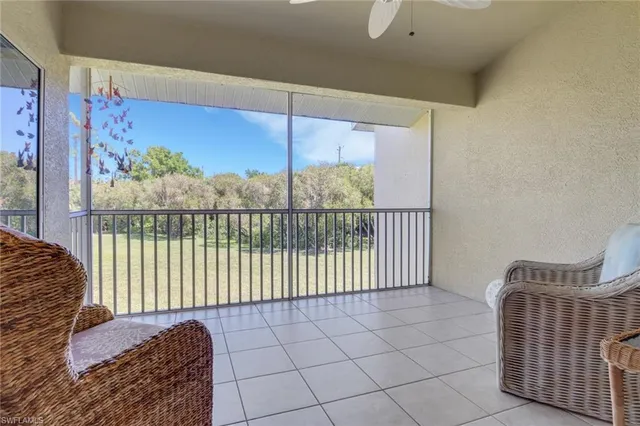 a living room with a couch and a potted plant