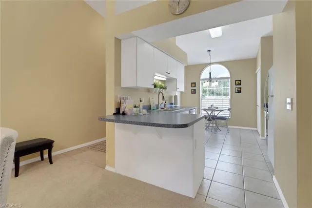 a kitchen with granite countertop a sink cabinets and window