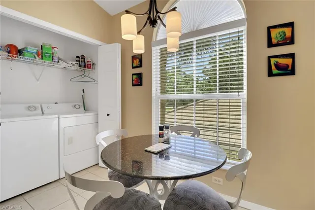 a living room with furniture a chandelier and a flat screen tv