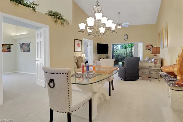 a view of a dining room with furniture and chandelier