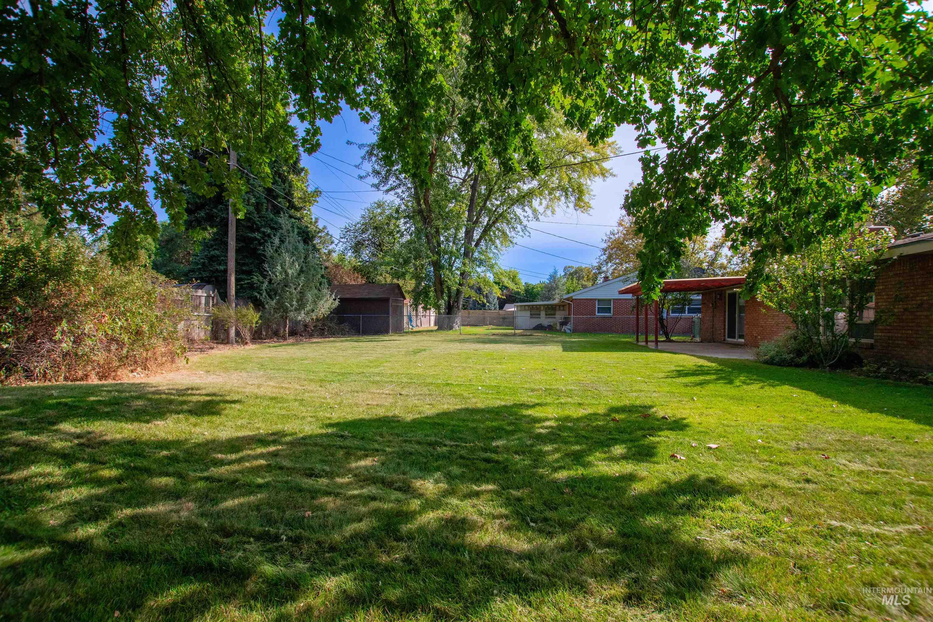 2716 North Redway Road Boise, ID 83704 - Photo 36 of 36 Expansive green lawn with mature trees and a detached shed