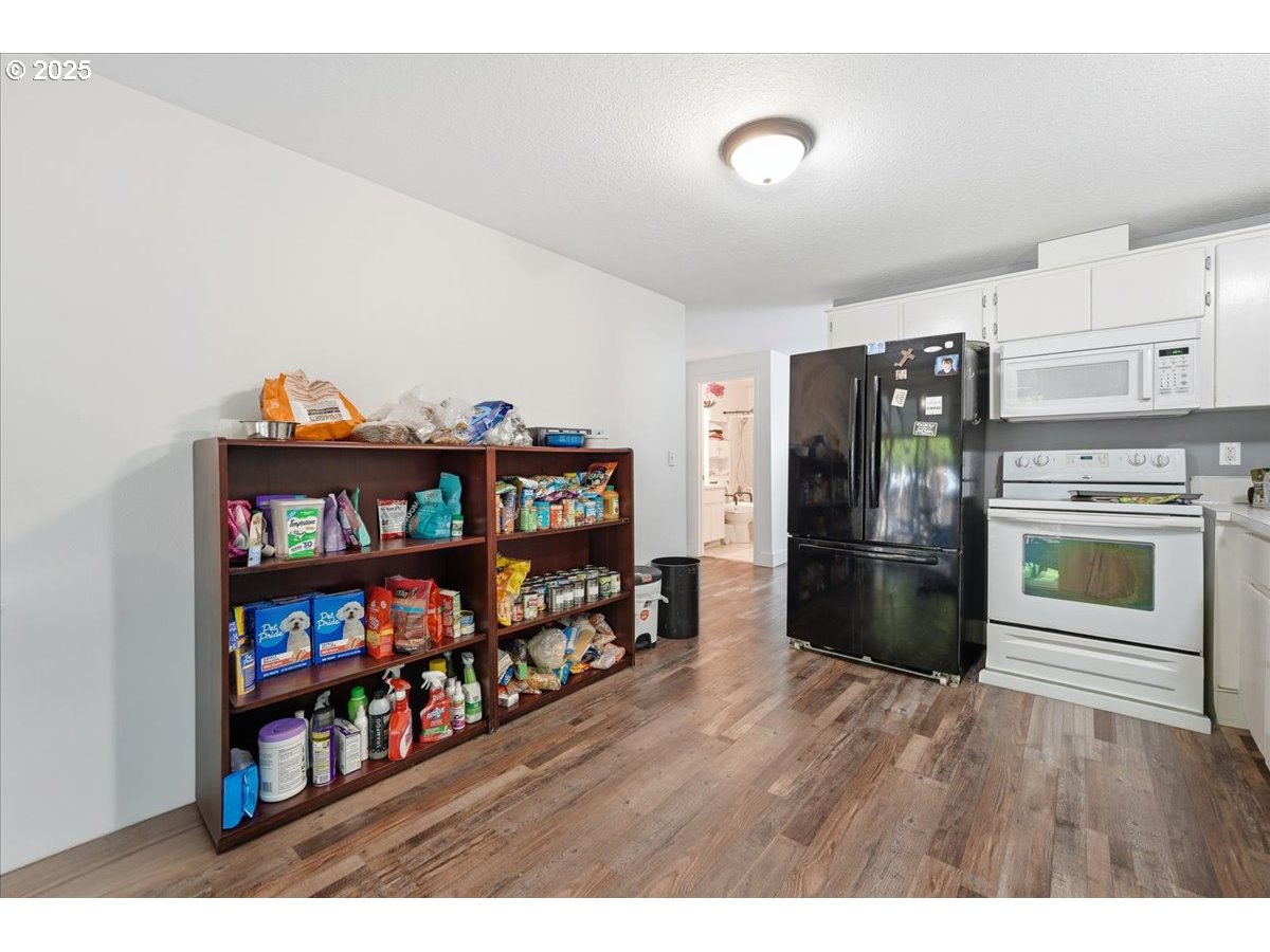 1802 Northwest 3rd Street Battle Ground, WA 98604 - Photo 9 of 16 a view of a workspace room with furniture and wooden floor