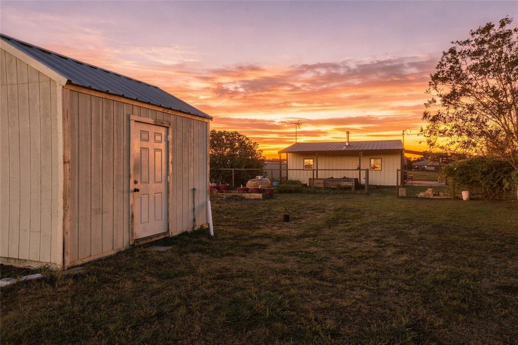 560 Green Acres Road Weatherford, TX 76088 - Photo 24 of 35 Metal-roofed outbuilding with a four-panel door