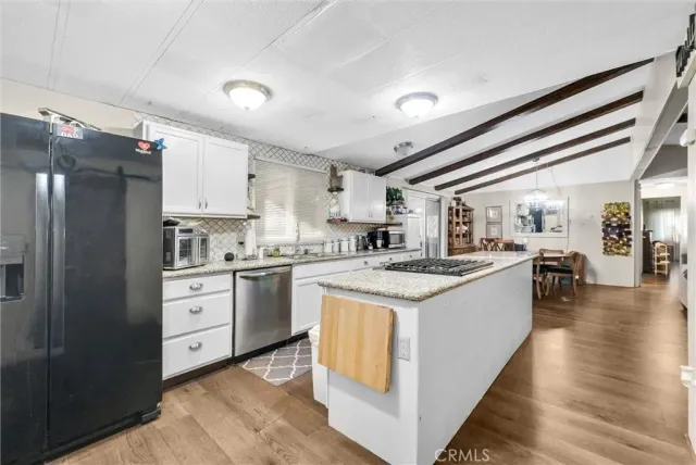 a kitchen with a stove and a refrigerator
