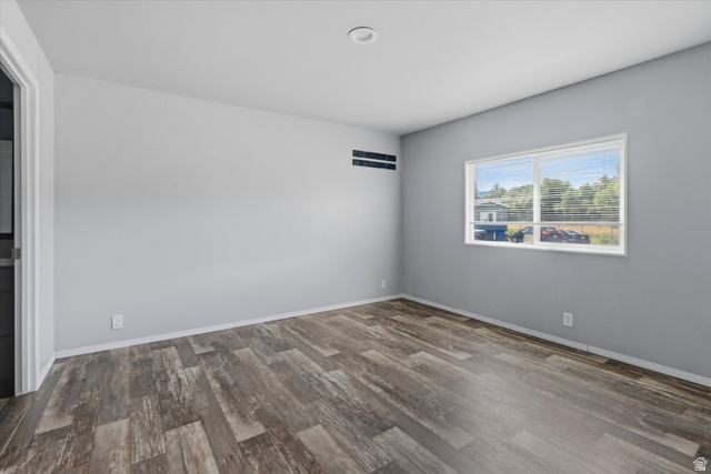 433 North 750 West Logan, UT 84321 - Photo 15 of 40 Spacious room featuring wood-finish flooring, light grey walls, and a large window with white blinds