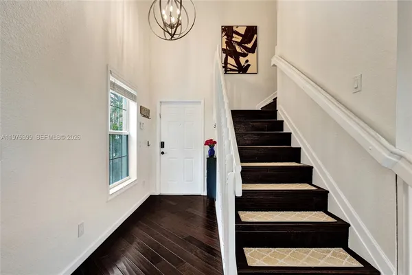 a view of entryway and hall with wooden floor