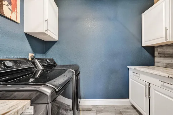 a garage with a white cabinets and furniture