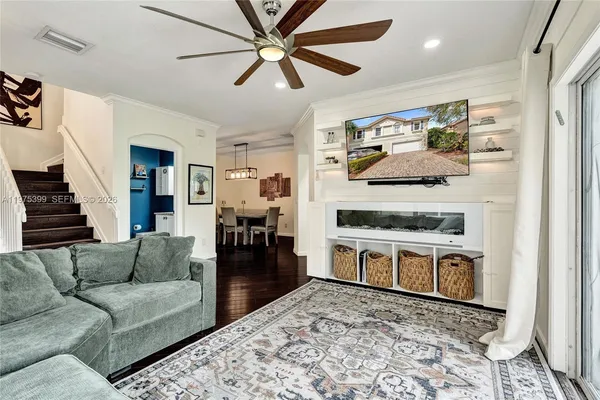 a living room with kitchen island furniture and a fireplace