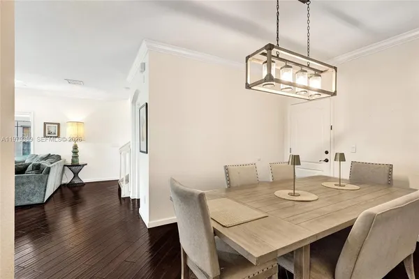 a view of a dining room with furniture wooden floor and chandelier