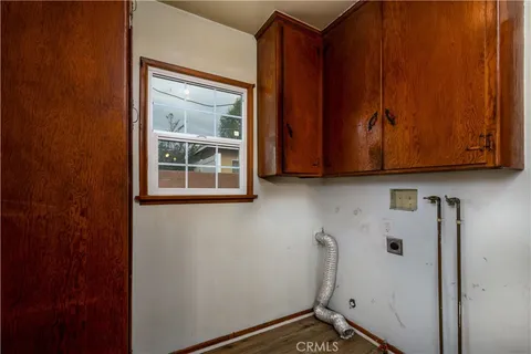 a view of a storage and utility room with cabinet