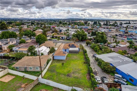 an aerial view of residential houses with yard