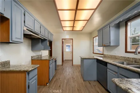 a kitchen with stainless steel appliances granite countertop a sink stove and cabinets