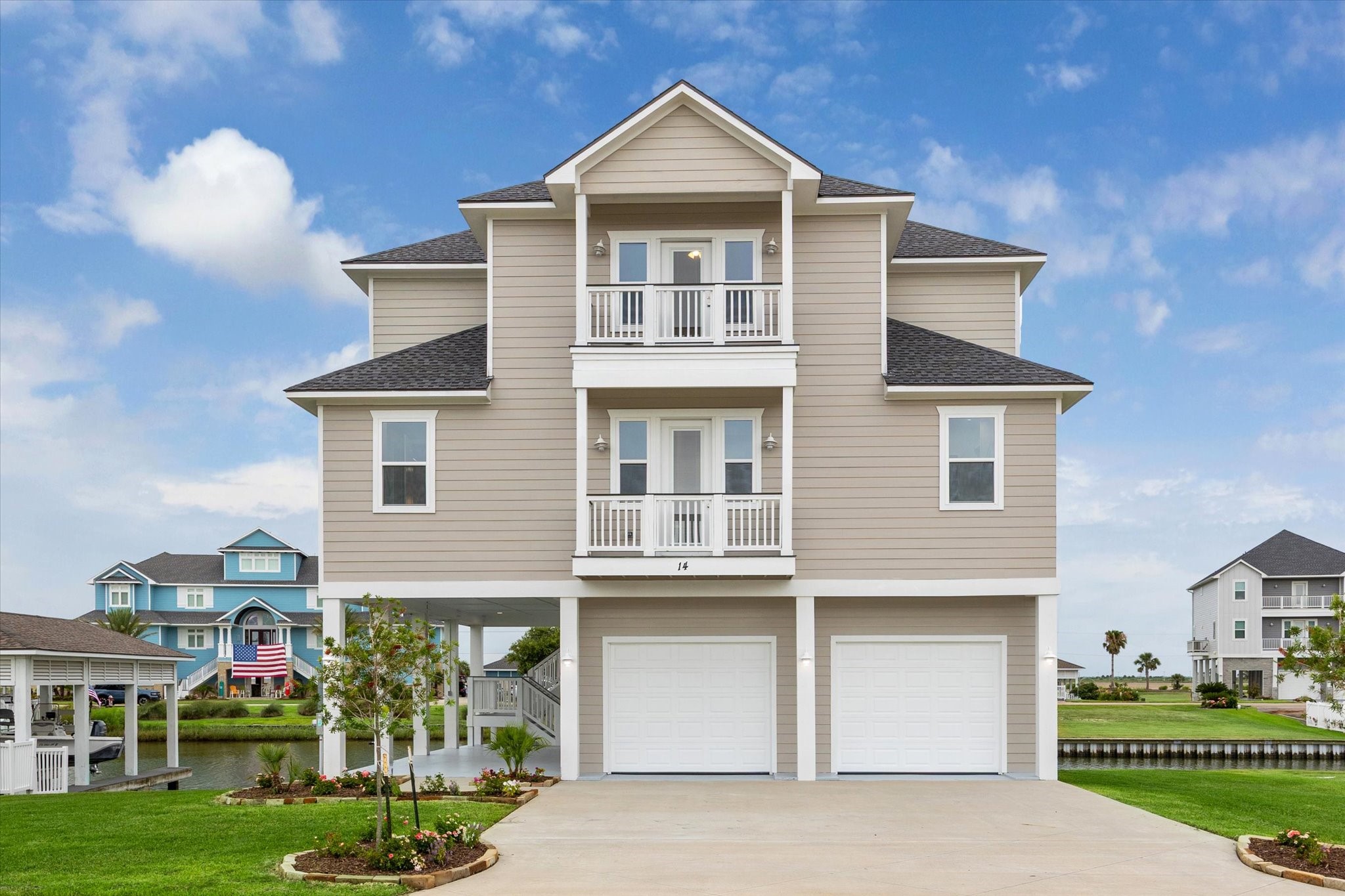 a front view of a house with a yard and potted plants