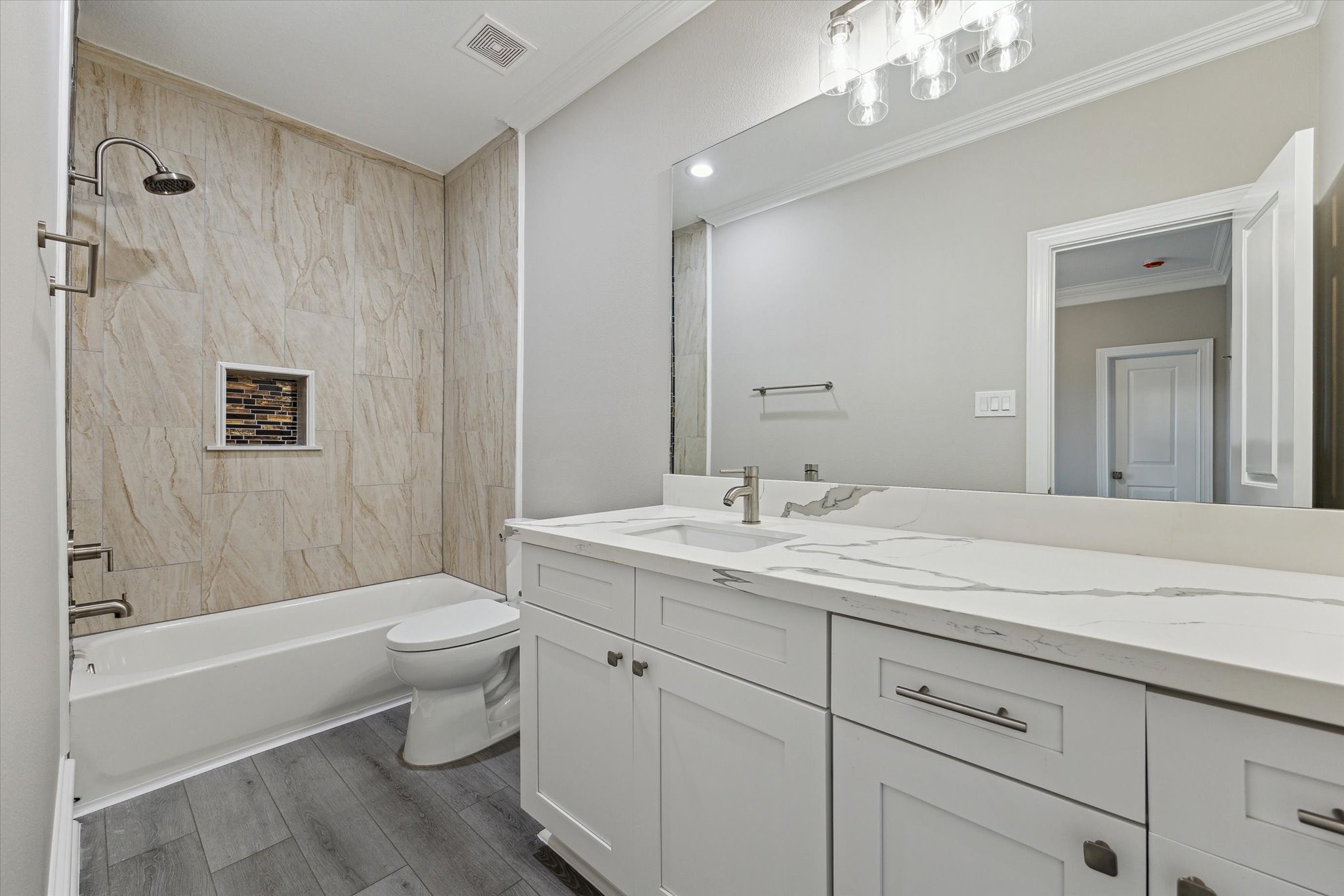 14 Fleming Hitchcock, TX 77563 - Photo 41 of 50 a bathroom with a toilet a sink a tub and a mirror