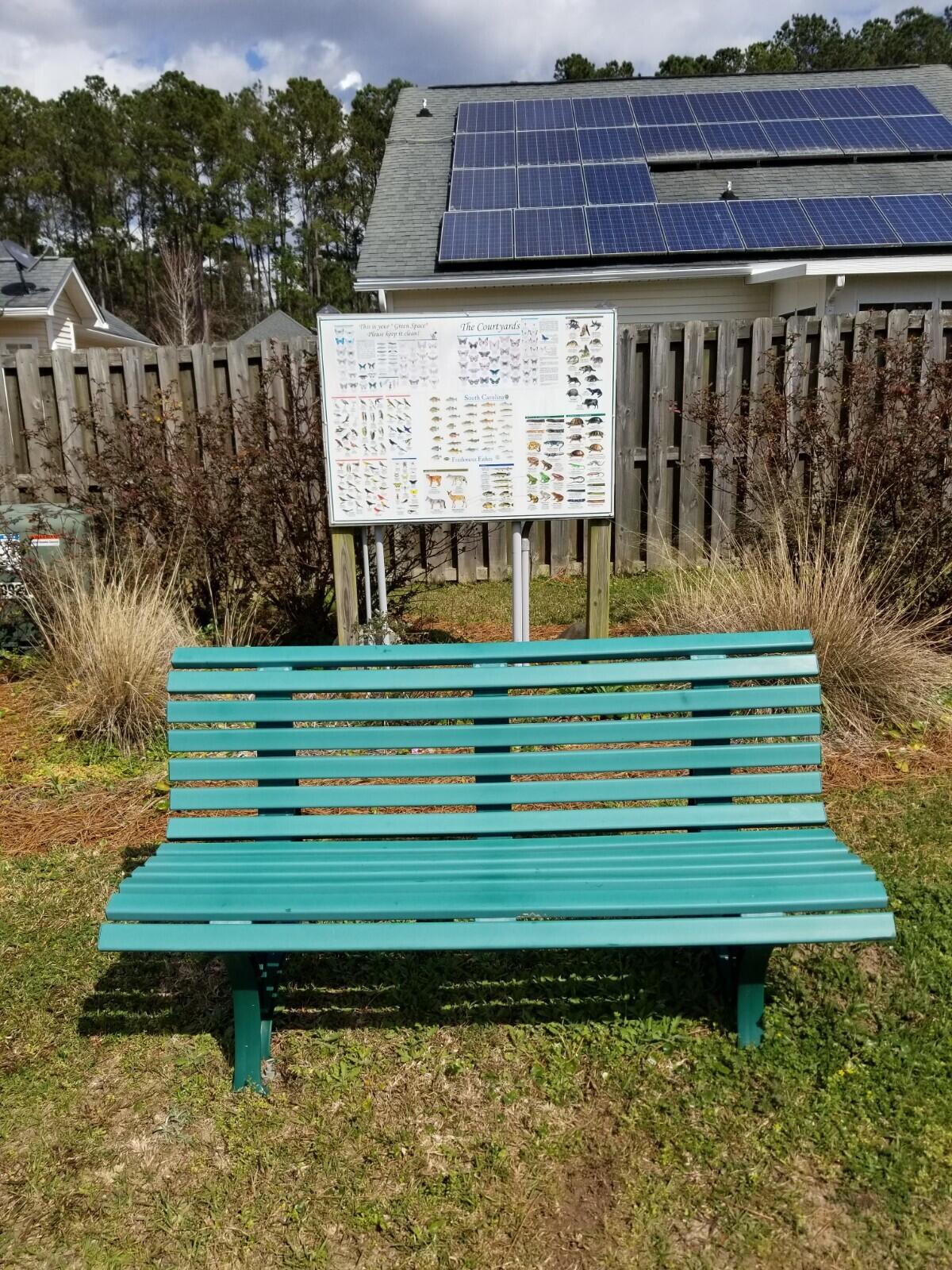 9289 Ayscough Road Summerville, SC 29485 - Photo 24 of 34 Courtyards bench and poster near pond