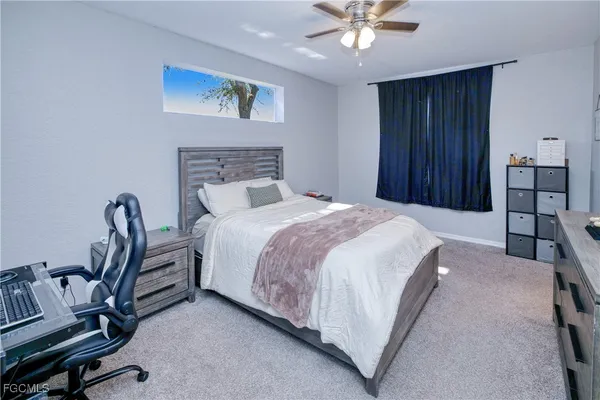 a bedroom with a bed a desk and chair