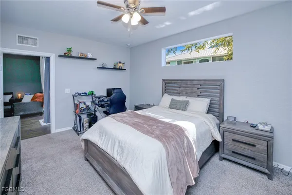 a bedroom with bed and a chandelier