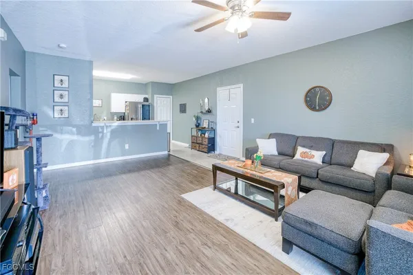 a living room with furniture and a wooden floor