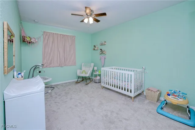 a bedroom with a small bed and a chandelier