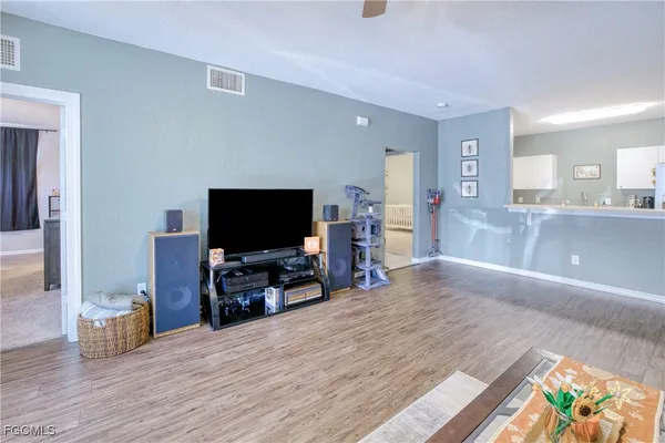 a view of a livingroom with furniture and a flat screen tv