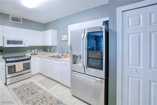 a kitchen with a white stove and refrigerator