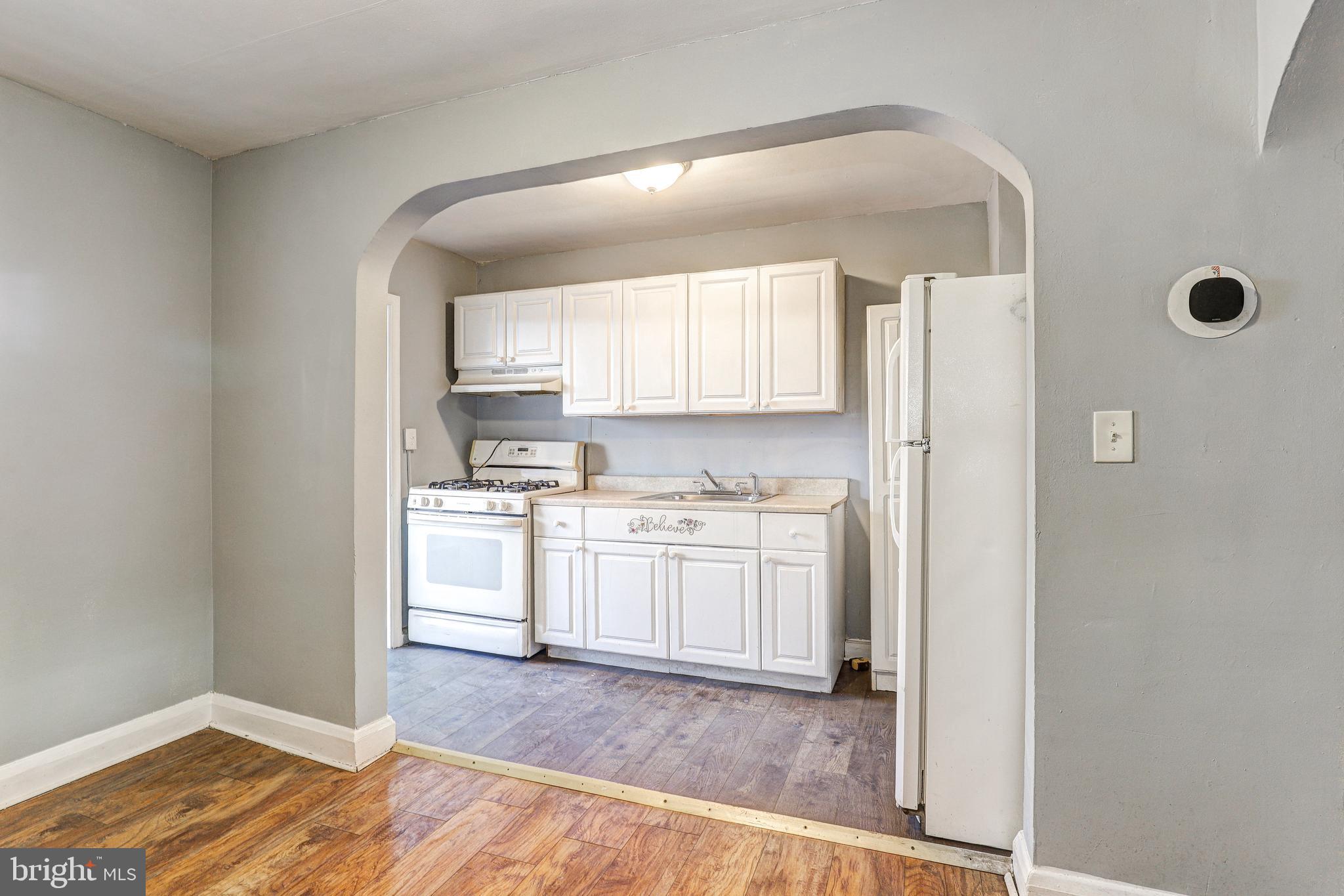 1913 Harman Avenue Baltimore, MD 21230 - Photo 11 of 41 a kitchen with granite countertop white cabinets and white appliances