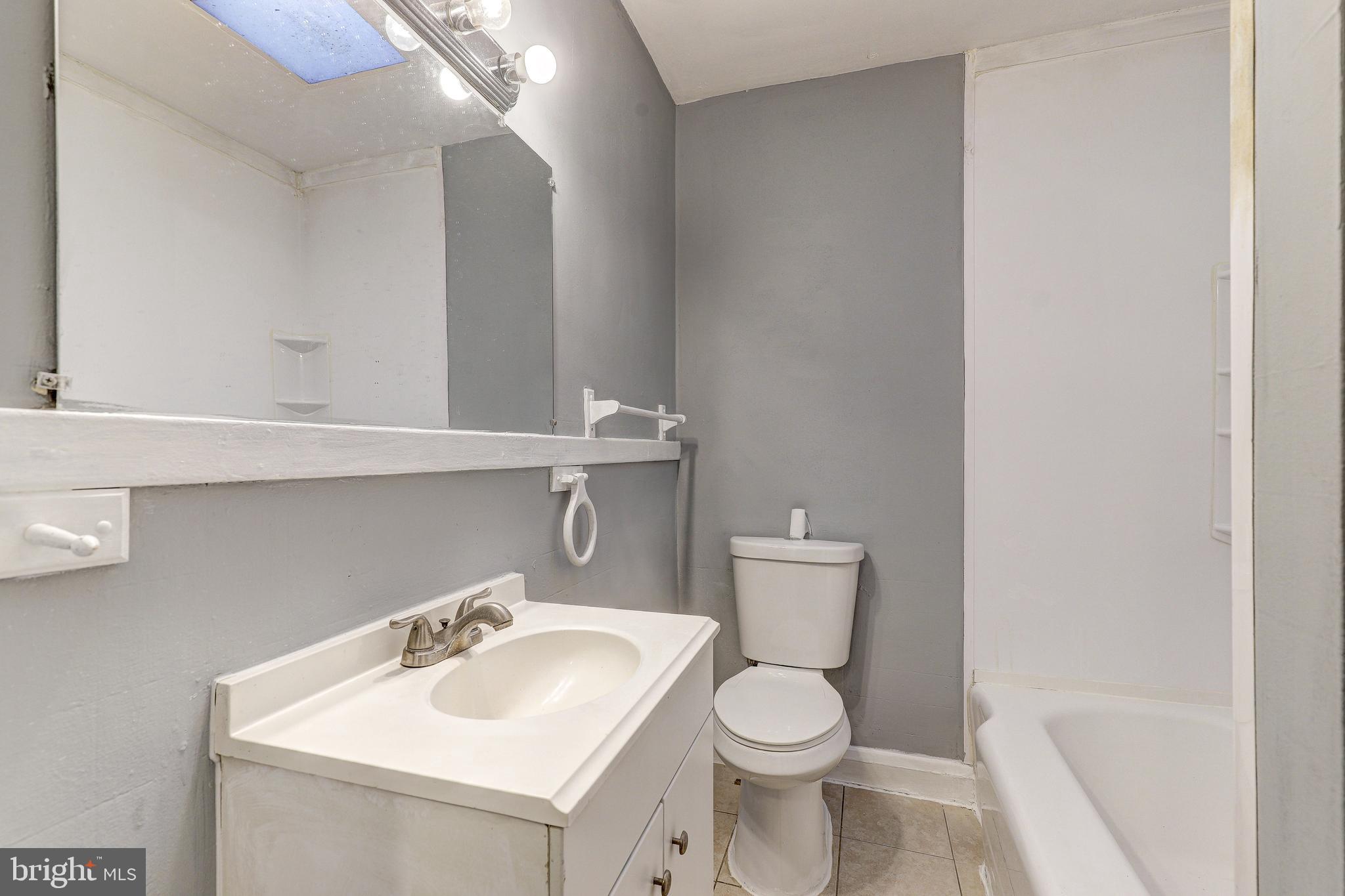 1913 Harman Avenue Baltimore, MD 21230 - Photo 22 of 41 a bathroom with a sink toilet and mirror
