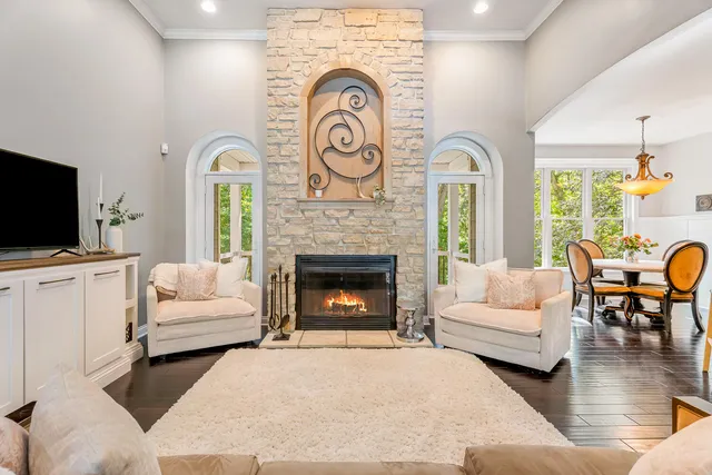 a kitchen with stainless steel appliances granite countertop a refrigerator a sink dishwasher a stove and white countertops with wooden floor