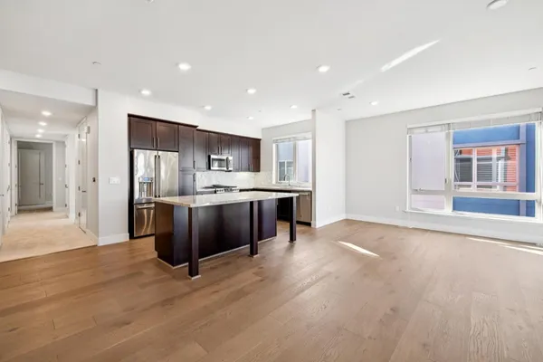 a kitchen with granite countertop a stove and a microwave