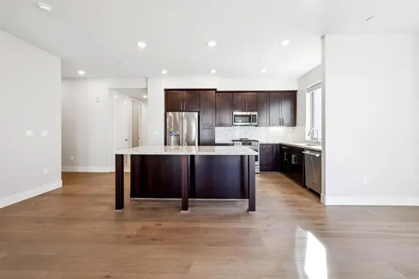 a kitchen with stainless steel appliances wooden cabinets and a sink