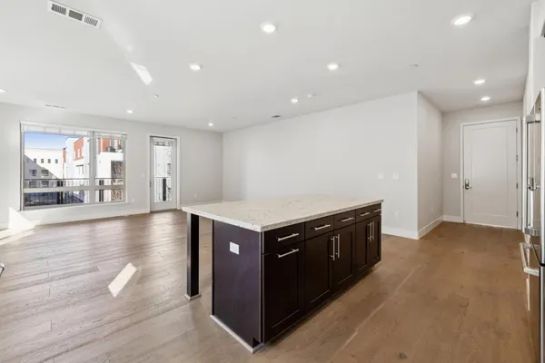 a kitchen with granite countertop stainless steel appliances and wooden cabinets
