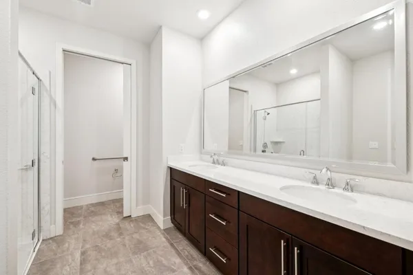 a view of washer and dryer with bathroom in the background