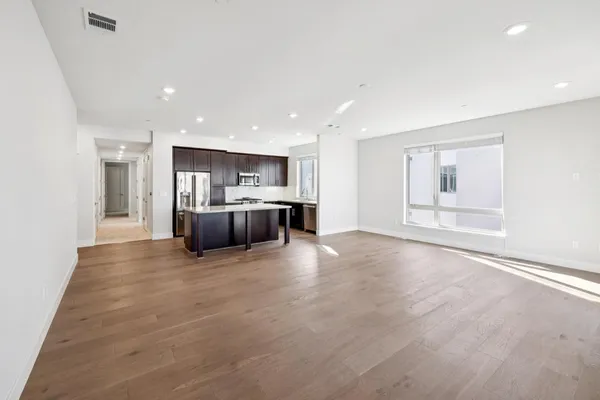 a view of an entryway with wooden floor