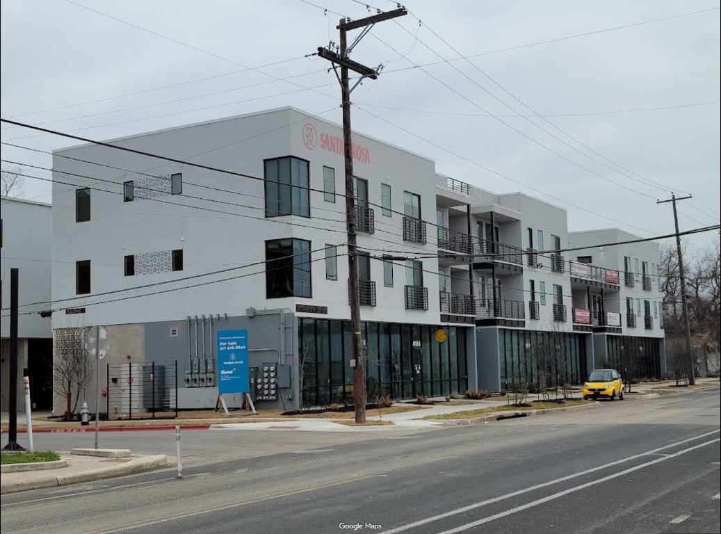 a city street lined with buildings and cars