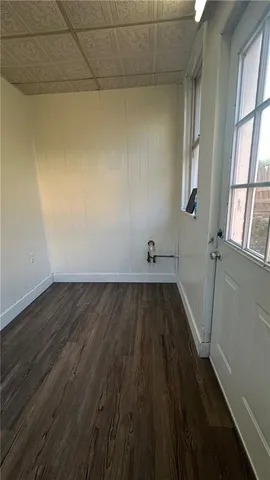 a view of a room with wooden floor and a window
