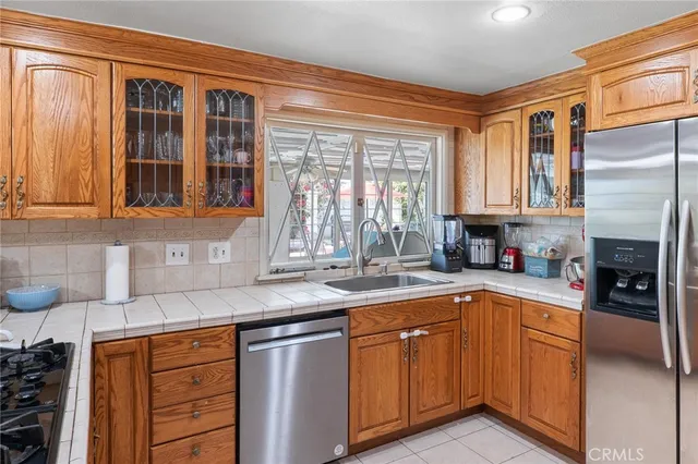 a kitchen with stainless steel appliances granite countertop a sink and cabinets
