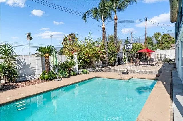 a swimming pool with outdoor seating and yard
