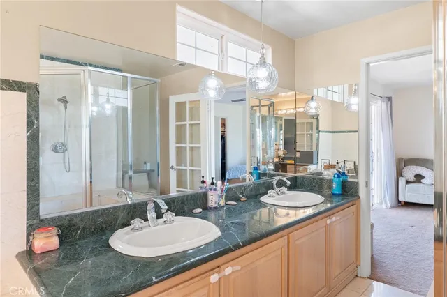 a bathroom with a double vanity sink and a mirror