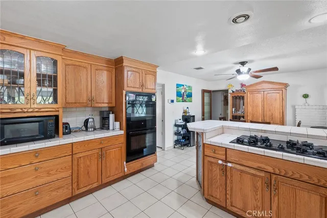 a kitchen with stainless steel appliances granite countertop a stove a sink dishwasher and cabinets with wooden floor
