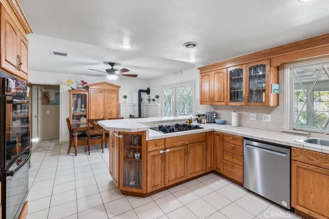 a kitchen with stainless steel appliances granite countertop a stove and a sink