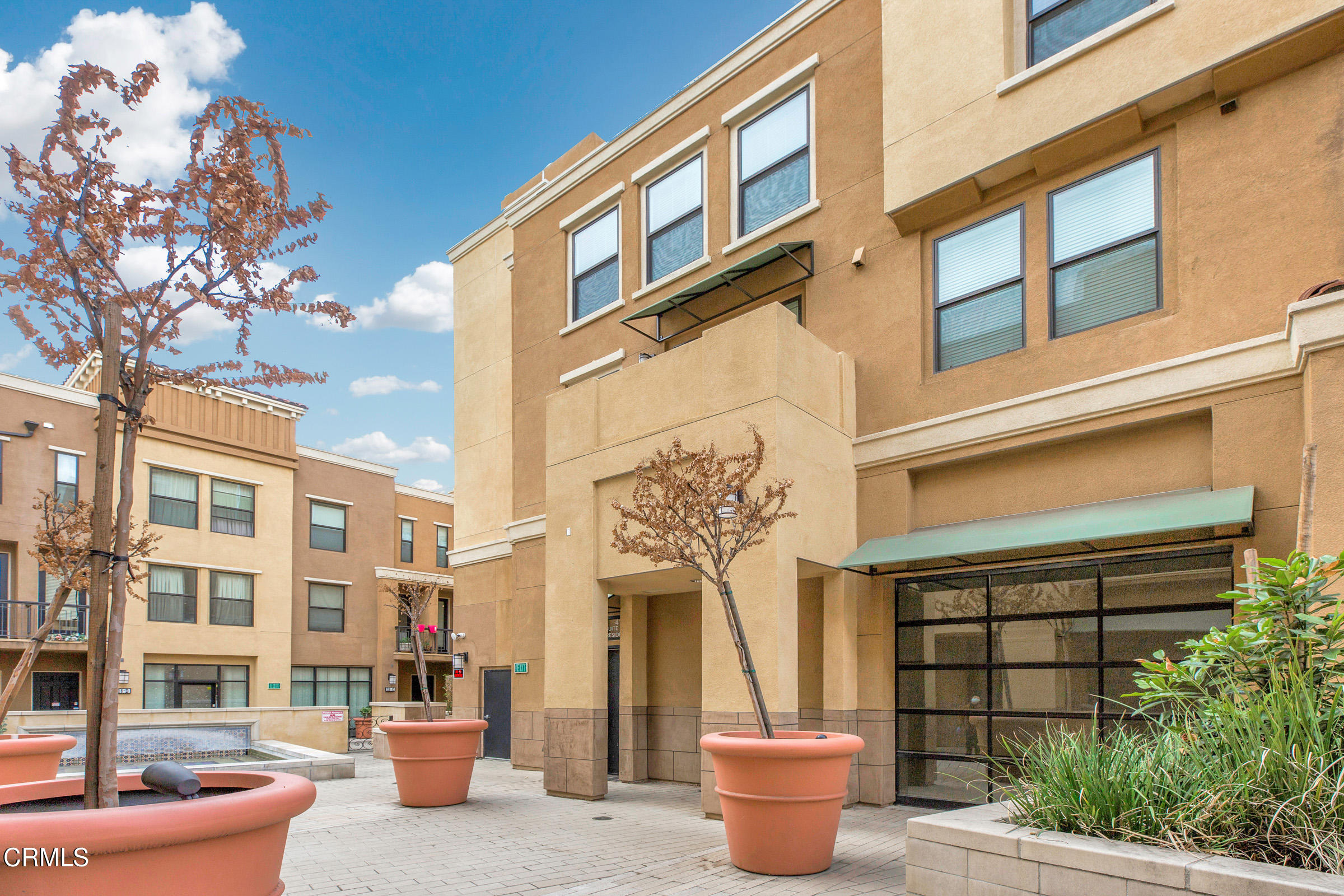 410 West Main Street, Unit 231 Alhambra, CA 91801 - Photo 4 of 45 a front view of a building with a potted plant and a large window