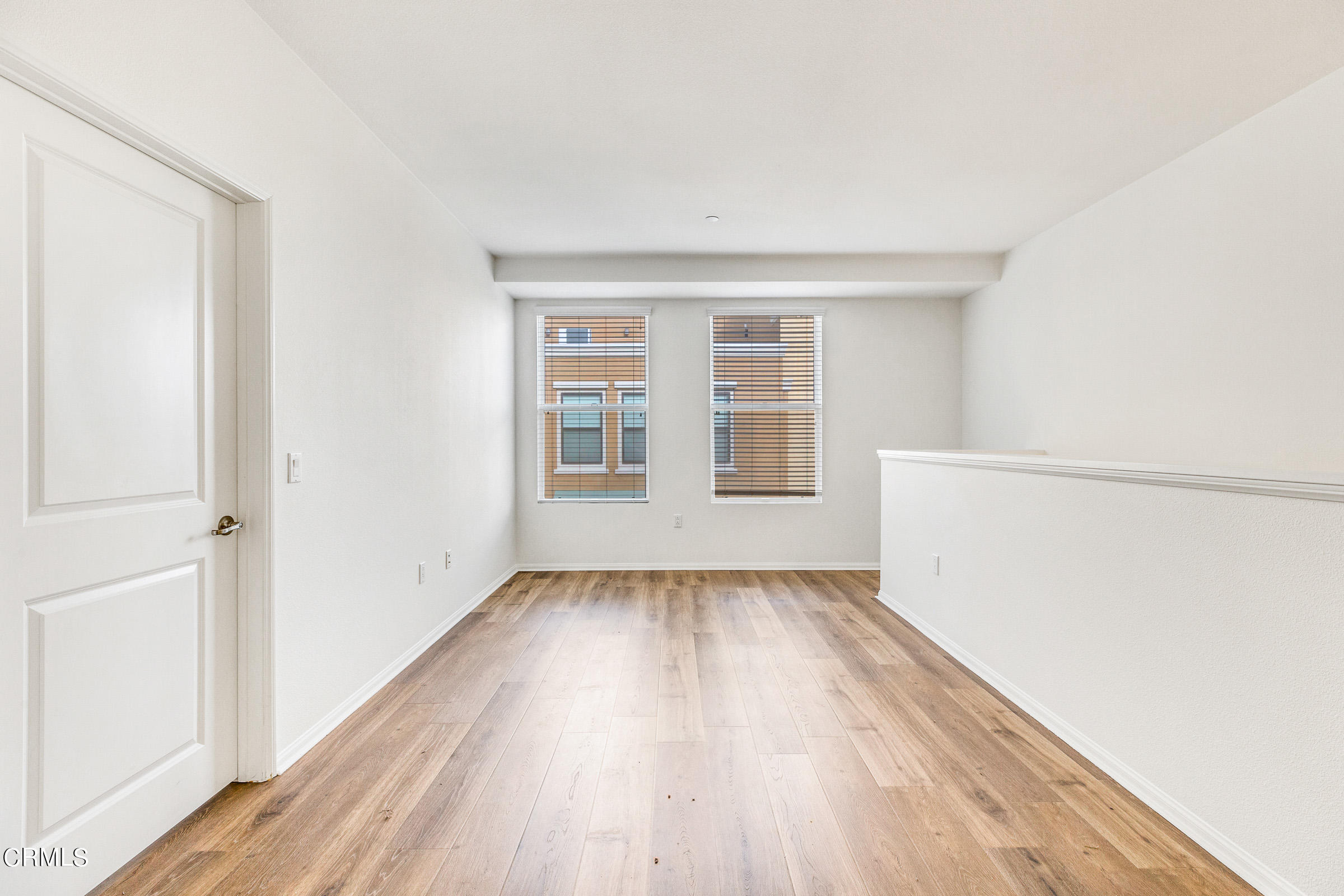 410 West Main Street, Unit 231 Alhambra, CA 91801 - Photo 33 of 45 an empty room with wooden floor and windows