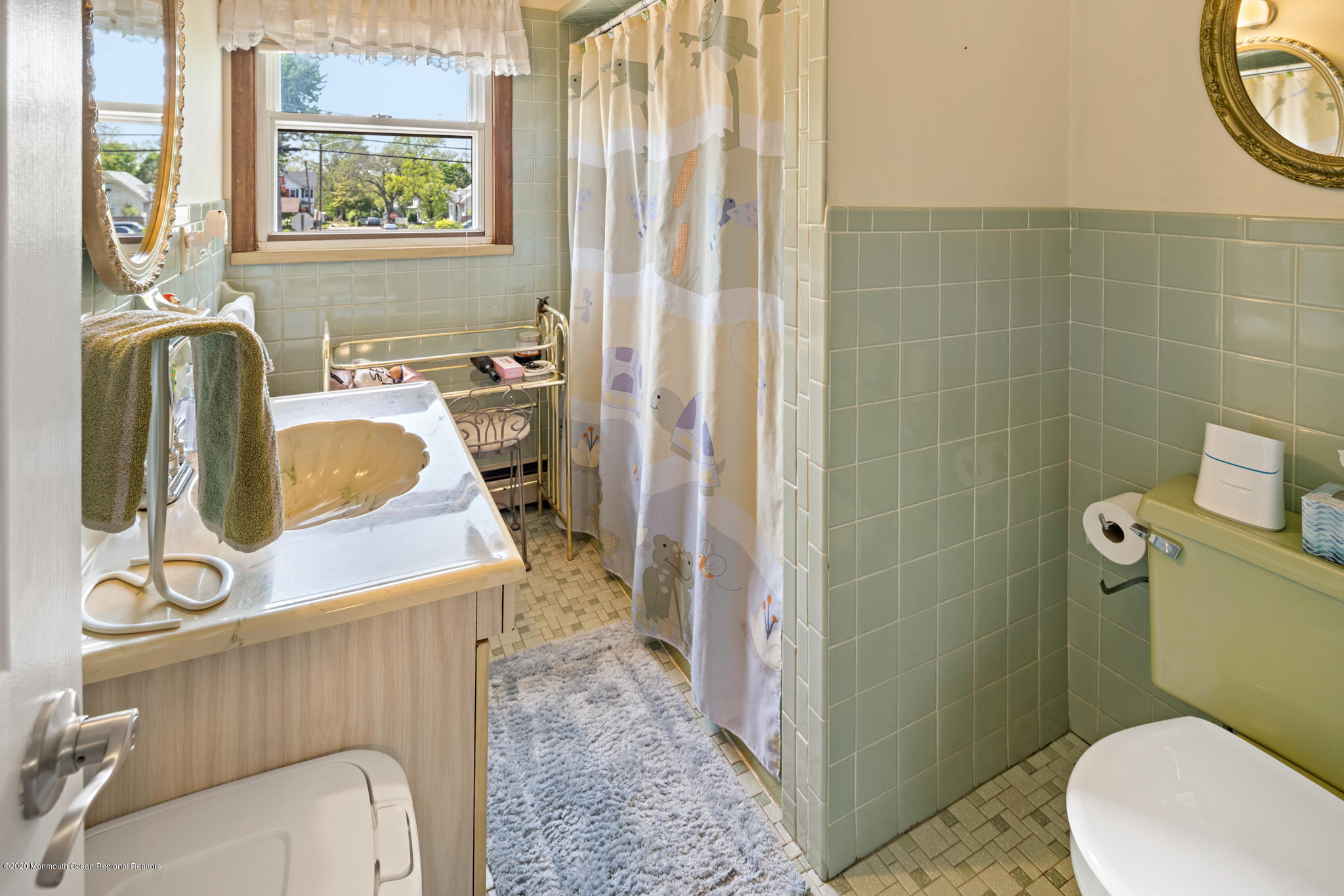 71 Broadway Keyport, NJ 07735 - Photo 23 of 27 a bathroom with a sink a toilet and a mirror