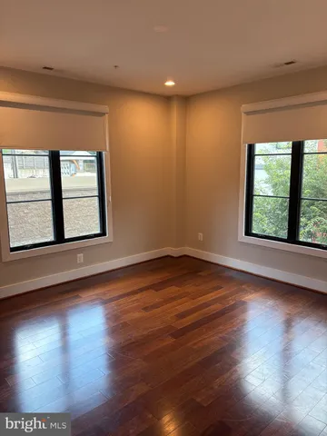 a bathroom with a granite countertop bathtub shower sink vanity and toilet